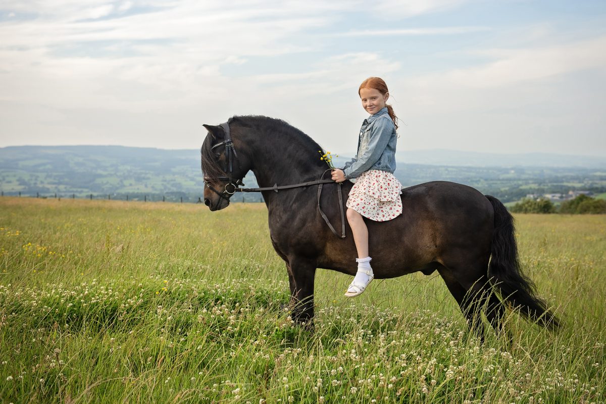 Young person with her Dartmoor pony during an equine portrait photoshoot in Lancashire.
